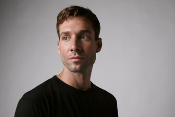 Portrait of handsome man wearing casual clothing posing over white background. Mental health.