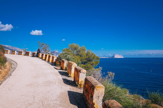 View from hiking trail to Albir lighthouse. View to Serra Gelada natural park, Calp, Penon de Ifach and Mediterranean Sea in sunny day. Costa Blanca, Alicante province, Valencian Community, Spain