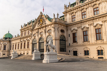 Belvedere Palace main entrance with statues and austrian flag waving in Vienna