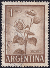 Argentinian stamp features a sunflower (Girasol), a symbol of joy and warmth, with a 1 peso...