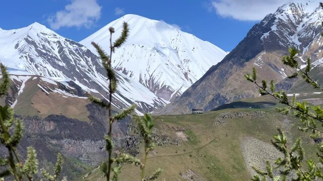 GUDAURI, GEORGIA - APRIL 26, 2024: Scenic view of the Devil's Gorge and the Arch of Friendship. The Caucasus Mountains in the area of the Peoples' Friendship Arch on the Georgian Military Road. 4K