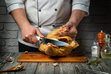 A culinary expert demonstrates their craft, skillfully carving a seasoned chicken on a wooden board. Aromatic herbs and spices surround the preparation area, enhancing the atmosphere