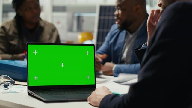 Shareholders use mockup laptop to project returns, assessing deal feasibility. Accountant in office using green screen notebook, performing financial analysis for interested investors