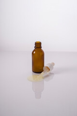 bottle oil with pipette on white background cosmetics