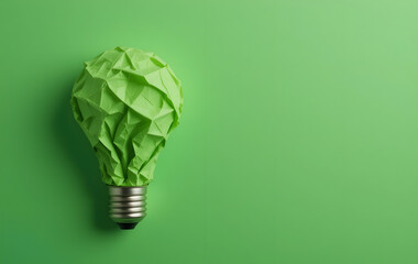 Creative idea, Inspiration, New idea and Innovation with Corporate Social Responsibility (CSR) concept, Green crumpled paper light bulb on green background.