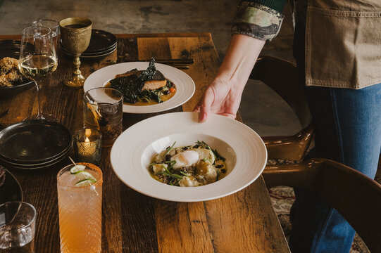 Hand Serving Dinner at a Restaurant