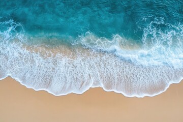 Aerial view of ocean waves crashing on a sandy beach creating a beautiful seascape from above the water