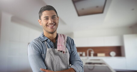 Obraz premium Smiling man in kitchen wearing apron, ready to cook with confidence