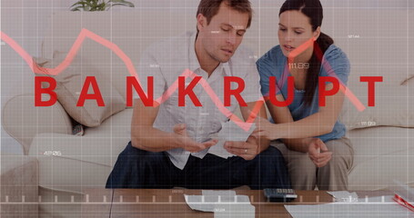 Couple reviewing finances at home, looking concerned with bankruptcy graph overlay