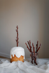 Easter table decorated with a homemade Easter cake on a stand, painted eggs and candles, morning...