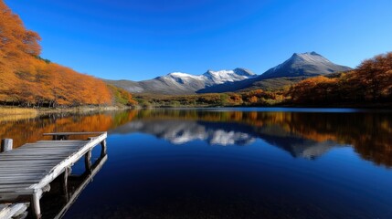 Fototapeta premium Serene autumn lake nestled amidst majestic mountains