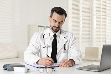 Fototapeta premium Cardiologist with stethoscope working at white table in clinic