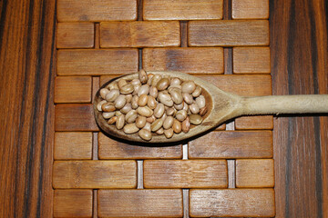 Pinto beans in the wooden rustic spoon. Brazilian grains.
