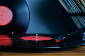 Turntable with vinyl record indoors, closeup view