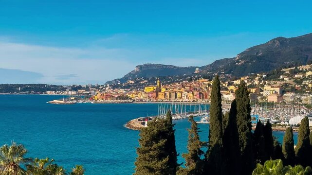 Panoramic view from above of colorful houses, marina and waterfront in Menton, Provence, Alps, Cote d'Azur France. High quality 4k footage