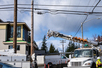 Utility digger derrick truck with pole setting equipment, ready to remove temporary wood powerline...