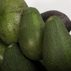 Close-Up of Fresh Ripe Avocados with Different Textures and Green Skins