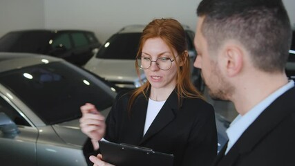 Professionals discussing vehicle features in an auto showroom during a business meeting about car sales strategies