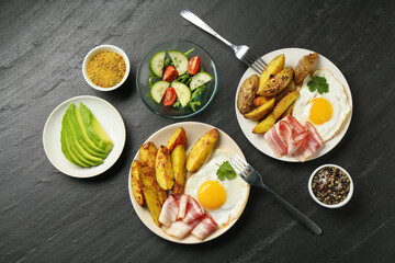 Flat lay composition with tasty brunch served on dark textured table