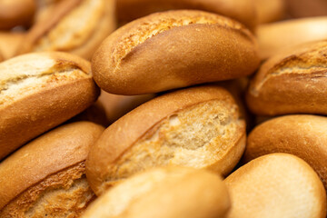 Freshly baked bread rolls in a wooden basket, perfect for breakfast or bakery product marketing, delicious golden crust and soft texture. Mini bread baguettes in basket. pieces to accompany food