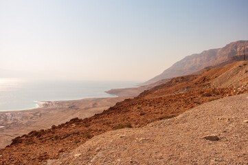 A rocky hillside overlooking a body of water