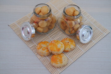 two small glass jars filled with golden brown bite sized cookies