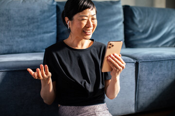 Woman tracking workout progress on fitness app after exercise