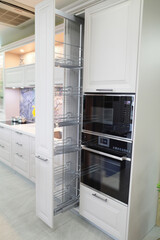 Fototapeta premium Modern Kitchen Design Featuring Sleek Cabinetry and Stylish Built-in Oven with Pull-out Storage Racks