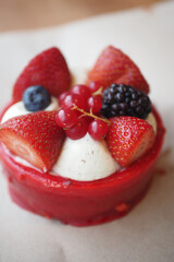 Delicious berry cake topped with fresh fruits in bright colors