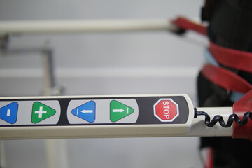 Control panel with stop and navigation buttons in use at facility