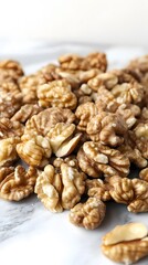 Obraz premium Closeup of Shelled Walnuts on Marble Background
