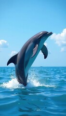 Fototapeta premium Dolphins breaching, showing powerful tails and sleek forms against blue water , powerful, dolphin, aquatic