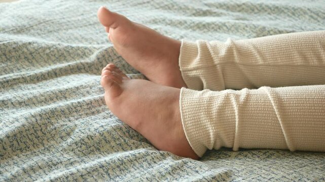 Relaxing moments with cozy legs on a soft bed