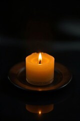there is a lit candle on a plate on a table