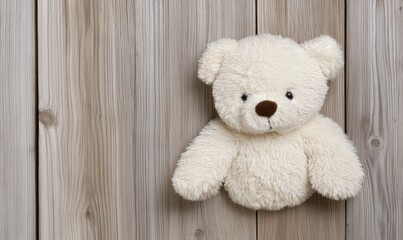 Obraz premium Cozy White Teddy Bear Hanging on a Wooden Wall for Children's Room Decor, Soft and Cuddly Toy for Babies and Toddlers with Rustic Atmosphere
