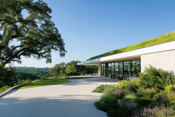 Modern building with green roof overlooking scenic valley landscape