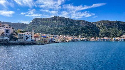 Colorful Waterfront Houses On Kastellorizo Island, Greece, Surrounded By Mountains And The Blue Sea, Idyllic Summer Destination, Traditional Architecture, Perfect For Travel, Tourism, And Cultural 