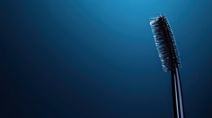 Beauty Product Close up of a mascara wand with black mascara, dark background, dramatic lighting emphasizes the product texture