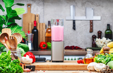 Healthy vegan eating, drinking, cooking, food blogging banner background with blender with bananas, raspberries and vegan milk for smoothies on wooden board
