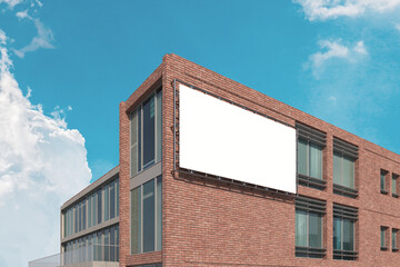 Blank billboard mounted on a brick building, perfect for showcasing advertisements,mockup,  announcements, promotions, or directions in an urban setting.