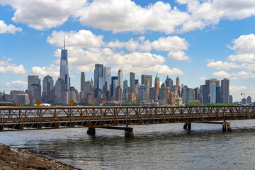 Fototapeta premium NYC skyline with skyscrapers. Manhattan and Brooklyn. New York City skyline with Hudson River views. Downtown NYC. New York from waterfront skyline. Landmark of of New York.