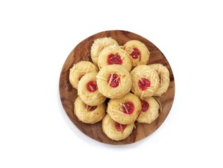 Nastar cake with strawberry jam on top on black plate isolated on white background, Top view 