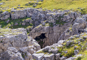 a trail on a rocky mountain plateau located on the path of a tourist route with an overview of the area