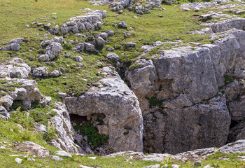 a trail on a rocky mountain plateau located on the path of a tourist route with an overview of the area