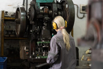 Engineer woman, factory and lather machine. Engineer woman at work in the industry factory, working...