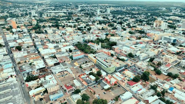 4K drone footage of downtown Ponce, Puerto Rico, featuring colonial architecture, the main plaza, and cityscape under bright skies. Ideal for travel, history, and cultural content.