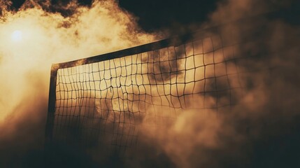 A volleyball net silhouetted against a smoky, golden-hued sky. The warm tones and hazy atmosphere create a dramatic and moody scene.