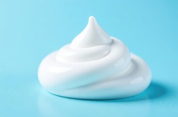 Face cleansing mousse sample. White cleanser foam bubbles on blue background. Soap, shower gel, shampoo foam texture closeup.