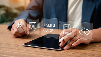 User manual guide concept, Online instruction manual and strategy advice. Businessman using laptop...