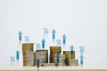 A stack of coins with upward arrows and percentage signs, representing financial growth, investment...
